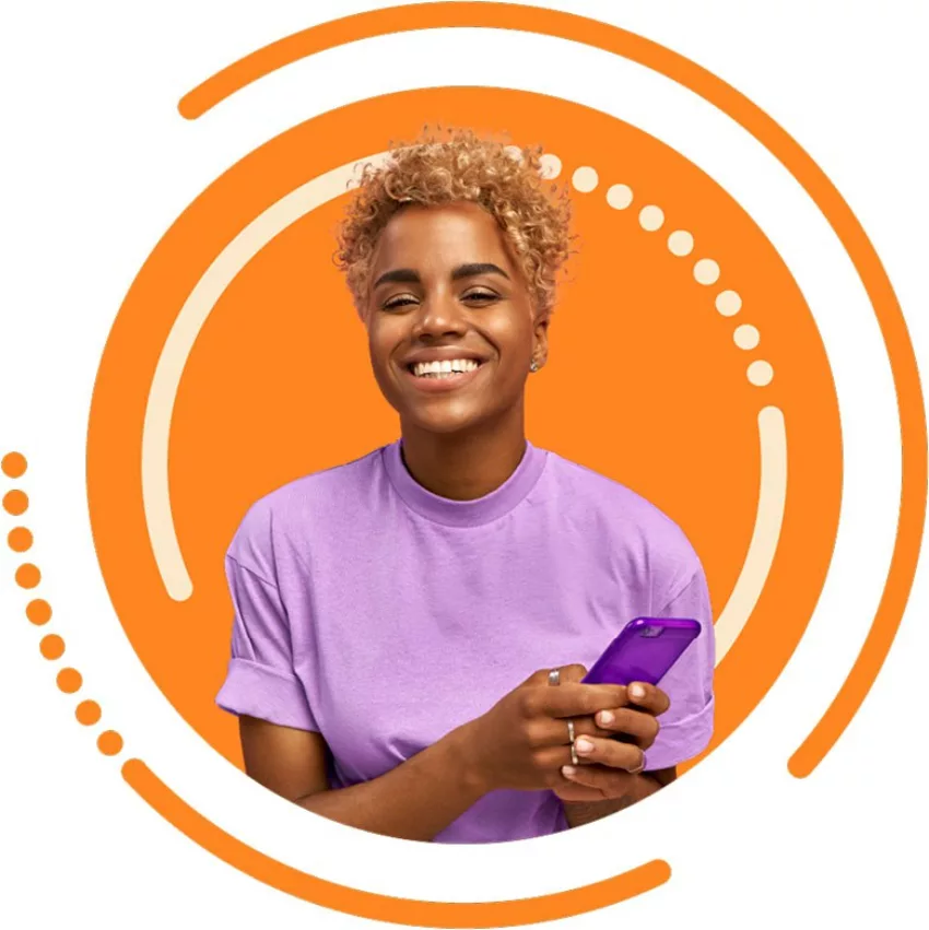 young adult smiling with phone in hand
